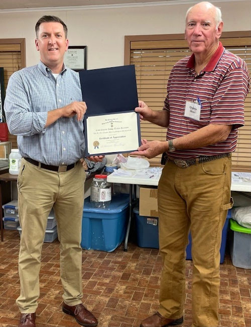 Chapter President Clarence Burns presents a Certificate of Appreciation to Cass County Judge Travis Ransom.