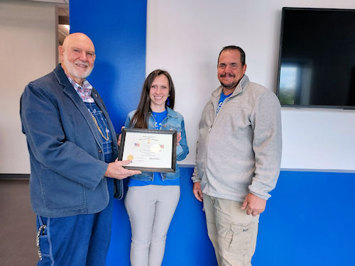 Adjutant Rodney Love presents the SAR Flag Certificate to Linden Elementary School Principal Holly Wall and Assistant Principal Jason Demsey.