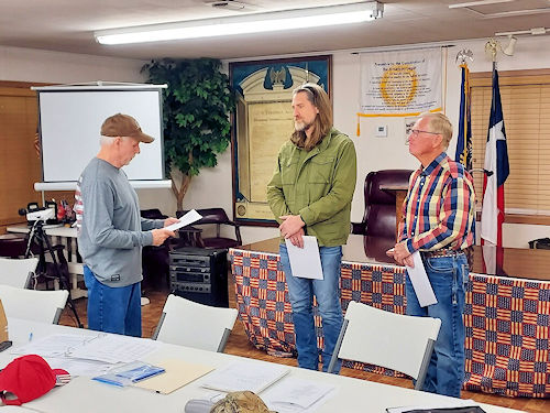 Registrar Dennis Beckham swears in Cody Lynn Howard and Jimmy Hilton Howard as new members of the Ark-La-Tex Chapter and the SAR.