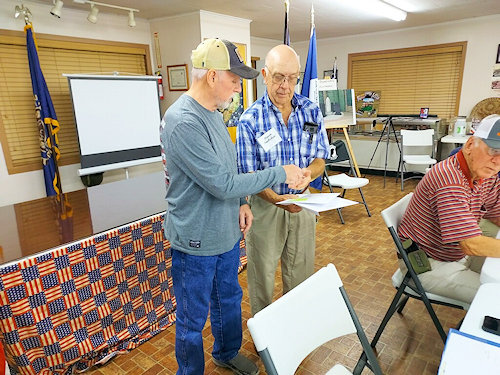 Registrar Dennis Beckham presents Compatriot Pat Tomberlain with his sons John Patrick and Jackson Wiley their certificate, challenge coin and rosets as new members to the Ark-La-Tex Chapter and the SAR.