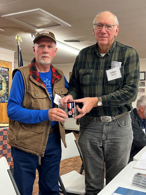 President Clarence Burns presents Registrar Dennis Beckham with The Texas SAR Chapter Service Medal.