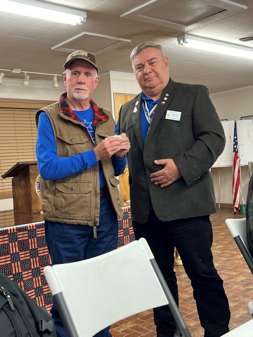 Chancellor Bill Sekel presents Registrar Dennis Beckham with the Recruiting Pin.